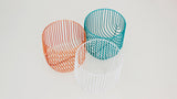 Collection of three sculptural wire baskets: aqua, orange, and white.