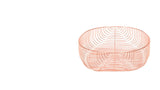 Large modern oval wire basket with shining copper finish and open design.