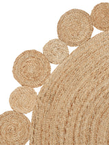 Natural hand-braided hemp rug featuring spiraling circular Daisy weave texture.