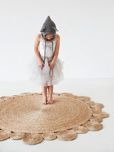Natural braided hemp rug featuring distinctive scalloped daisy-weave edges.