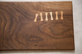 Detail of rich dark walnut wood grain with contrasting Arikata butterfly joinery.