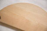 Light maple wood grain and small dark speck on Evn Stevn cutting board.