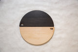 Ebonized oak and natural wood of the semi-circle cutting board, showing left handle.