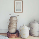 Stacked natural Olli Ella hand-woven seagrass belly baskets with handles, 16 inches.