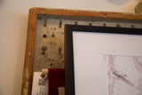 Corner of the black framed Farm Nuzzling Horse photograph and white mat.