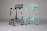Modern low back wire stools, black and aqua, with geometric bases.
