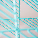 Detailed view of the modern stool's turquoise powder-coated wire grid.