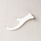 White glazed porcelain deer antler with elegant gold tips, 6x3 inches.