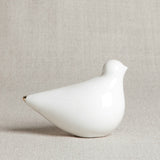 Handmade porcelain turtle dove with glossy white finish and elegant gold tip.