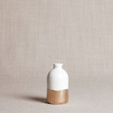 Lower section of white bud vase, featuring hand-painted gold leaf brushstrokes.