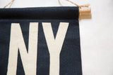 Cream felt 'Y' letter with hand stitching, navy felt, oak dowel, and jute string hanger.