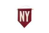 Crimson felt NY pennant with cream hand-sewn letters and an oak dowel.