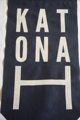Horizontally placed cream felt 'H' on the navy Katonah banner.