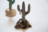 Dark speckled ceramic cactus totem with a ring, showcasing its glazed detail.