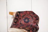 Antique Lilihan rug's raspberry red field with navy blue floral and sickle leaf motifs.
