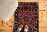 Distressed antique Lilihan rug showing raspberry red field with expressive medallion and sickle leaf designs.