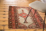 Distressed antique Malayer rug with camel field, diamond medallion, tomato red border.