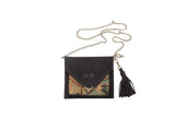 Handmade rug fragment bag in black suede with an envelope flap and silver chain strap.