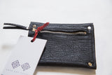 Black textured coin purse with silver metal zipper, red ribbon pull, and white brand tag.