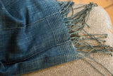 Vintage indigo throw with hand-woven texture, pieced panels, and blue fringe.