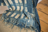 Detail of hand-stitched patch and fringed edge on the indigo blue Batik Throw.