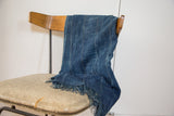 Handwoven vintage indigo cotton throw with textured vertical stripes and fringe.