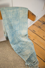 Hand-woven vintage indigo throw with supple texture and varied light blue tones.