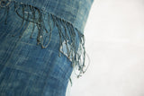 Deep blue vintage African indigo textile with textured surface and intact fringe.
