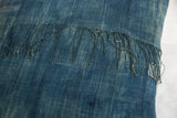 Textured blue African Indigo floor pillow textile with original, aged fringe.