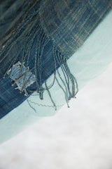 African Indigo Floor Pillow: vintage dark blue textile, frayed fringe, light blue linen, mended patch.