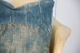 Vintage African Indigo pillow showing sun-faded textile and loose threads.