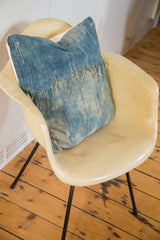 African Indigo Throw Pillow, showing sun-faded vintage textile texture and frayed edge.
