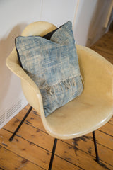 African Indigo pillow detail, showing frayed fringe and textured sun-faded blue textile.