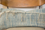 Close-up of African Indigo pillow showcasing sun-faded blue texture and frayed textile.