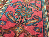 Antique Lilihan Persian rug with vibrant geometric patterns over distressed red and blue, 2'2