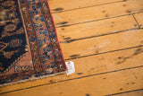 Antique Malayer rug border: distressed texture, navy blue field, dusty rose, red secured side.