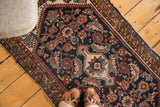 Distressed vintage Malayer runner shows faded navy, red, and sky blue Herati patterns.