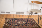 Vintage distressed Malayer runner, displaying Herati pattern, tattered sides, and rich aged colors.