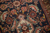 Distressed navy, madder red, and ivory Herati pattern on a vintage Malayer rug runner.