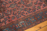 Distressed Herati pattern in faded raspberry red and indigo blue with visible wear.