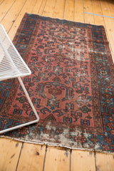 Worn hand-knotted pile and exposed foundation of an antique Malayer rug.