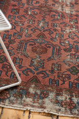 Antique distressed Malayer rug with worn raspberry, indigo pile, exposed foundation, Herati motif.