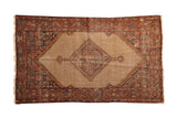Distressed vintage Hamadan rug, serrated diamond medallion, lattice pattern on a camel field.
