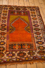 Tangerine orange Ladik mehrab, olive green field, and geometric border patterns.