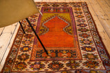 Hand-knotted Oushak rug border showing geometric patterns and orange to ivory color migration.