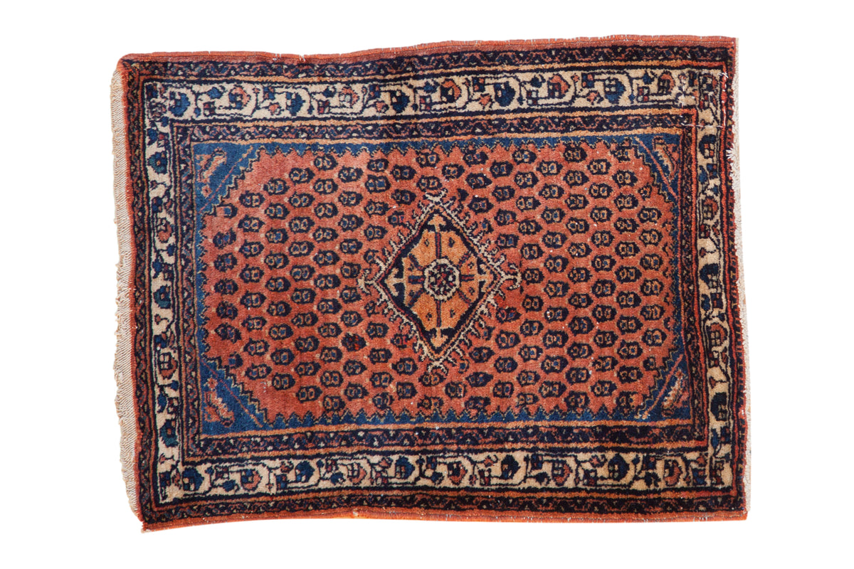 Vintage Engelas Persian rug with a geometric medallion on a rust-red field with dark blue accents.