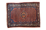 Vintage Engelas Persian rug with a geometric medallion on a rust-red field with dark blue accents.