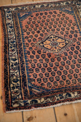 Close-up showing the navy blue spandrel and ivory border of a vintage Engelas rug.