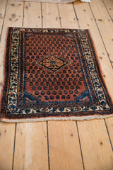 Vintage Persian Engelas rug mat with a rust-red geometric pattern, viewed from a high angle.