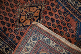 Folded corner of the vintage Engelas rug showing its hand-knotted back and pattern.